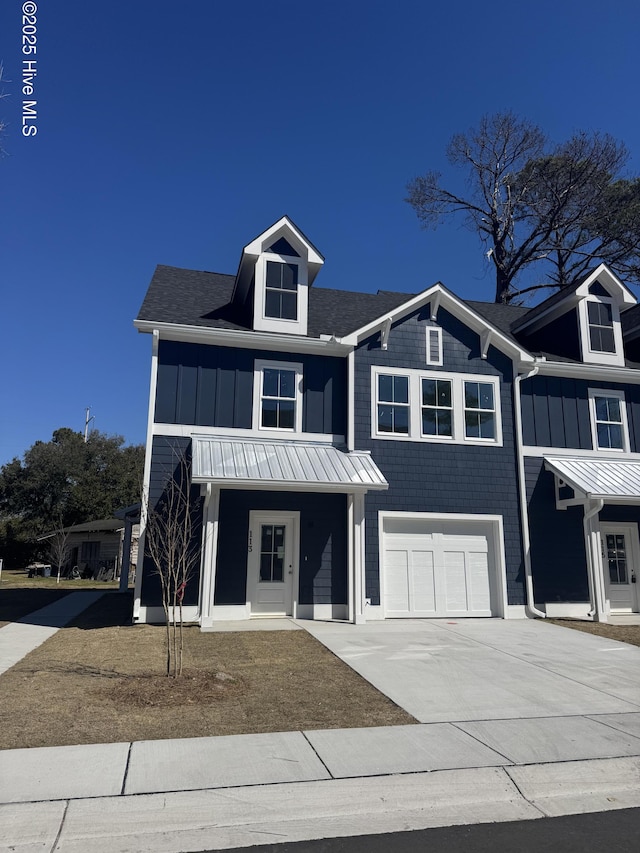 view of front of property featuring a garage, board and batten siding, and concrete driveway