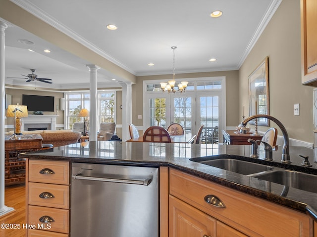 kitchen featuring dishwasher, crown molding, ornate columns, a fireplace, and a sink