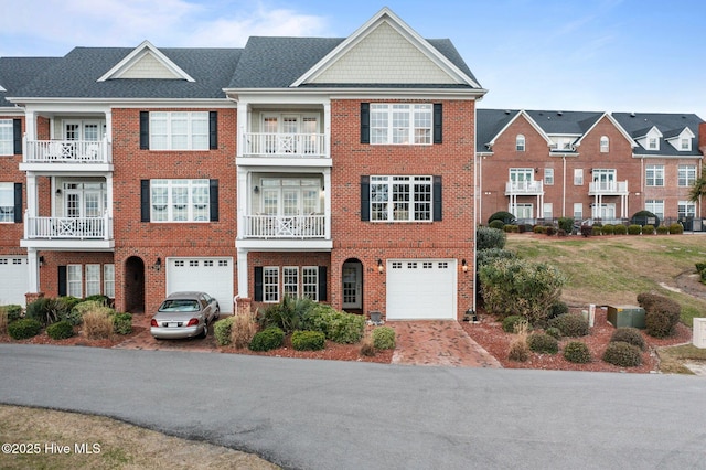 view of front of home with an attached garage and brick siding