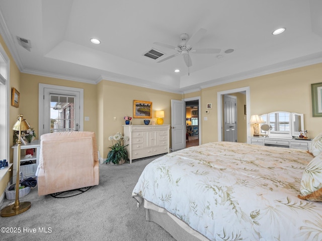 bedroom with crown molding, a tray ceiling, carpet flooring, and recessed lighting