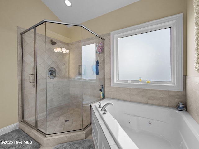 full bath featuring a jetted tub and a shower stall