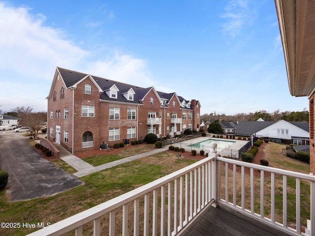 wooden deck with a residential view and a yard