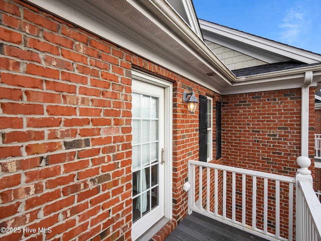 entrance to property featuring brick siding