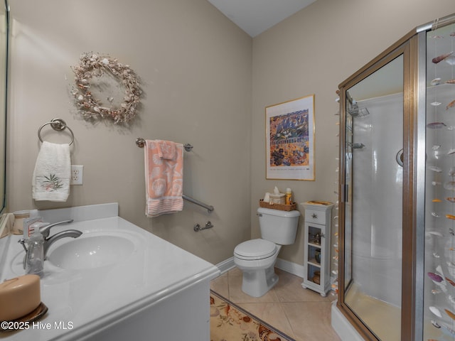 bathroom featuring baseboards, toilet, tile patterned floors, vanity, and a shower stall