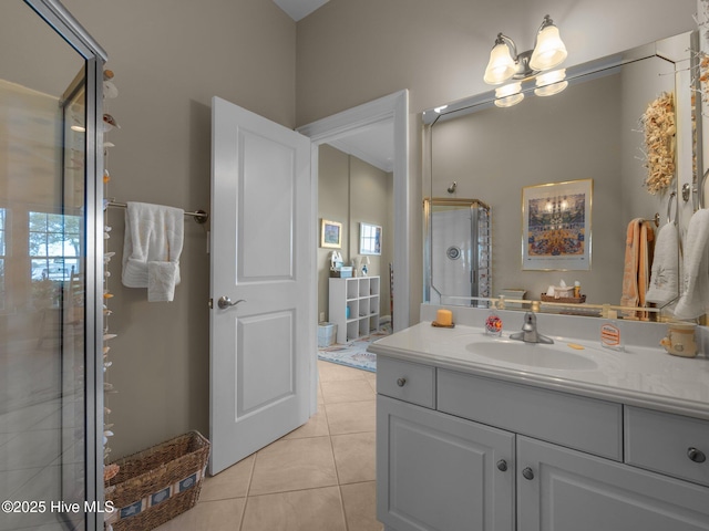 bathroom with a stall shower, vanity, and tile patterned floors