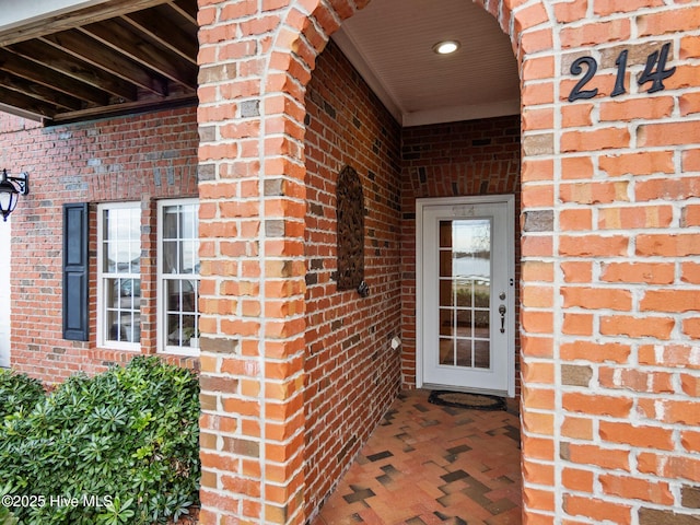 entrance to property with brick siding