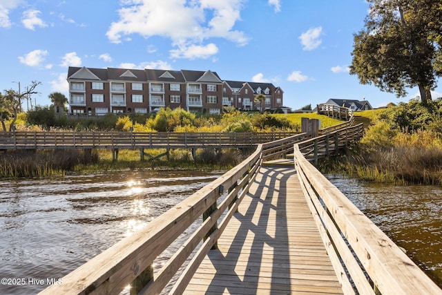 dock area featuring a residential view and a water view