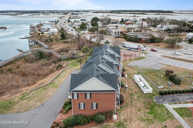 bird's eye view with a water view and a residential view