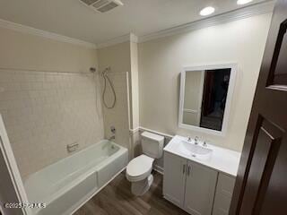 bathroom featuring visible vents, toilet, ornamental molding, vanity, and shower / bathtub combination