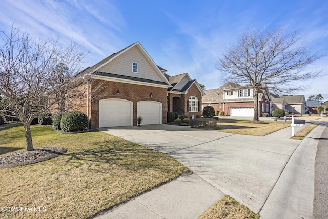 view of front of property with a front yard, brick siding, and driveway