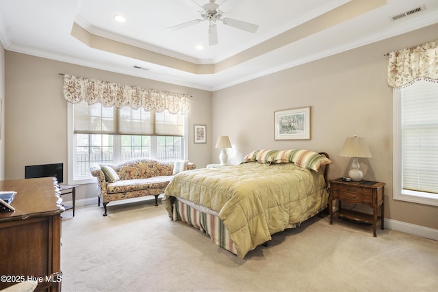 bedroom featuring baseboards, a tray ceiling, visible vents, and light colored carpet