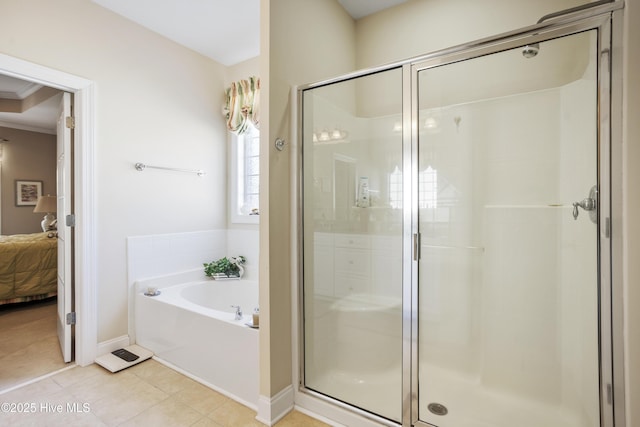 bathroom featuring a stall shower, tile patterned floors, a bath, and ensuite bathroom