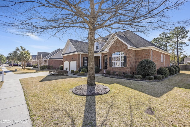 view of front of home featuring a shingled roof, a front yard, crawl space, and brick siding