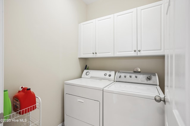 laundry area with cabinet space and independent washer and dryer