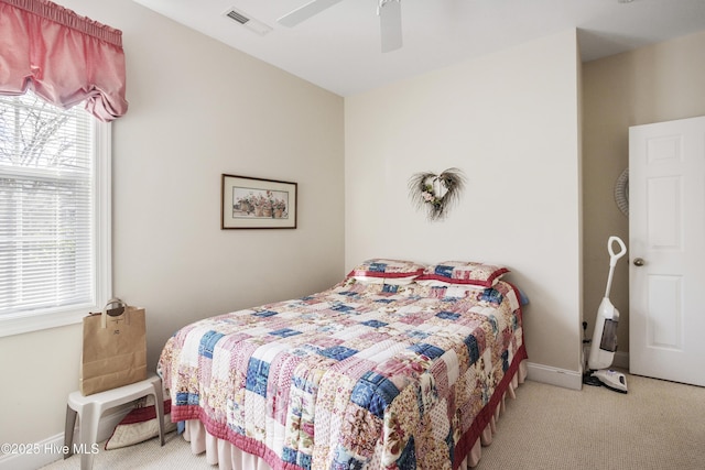 bedroom with baseboards, multiple windows, visible vents, and carpet flooring