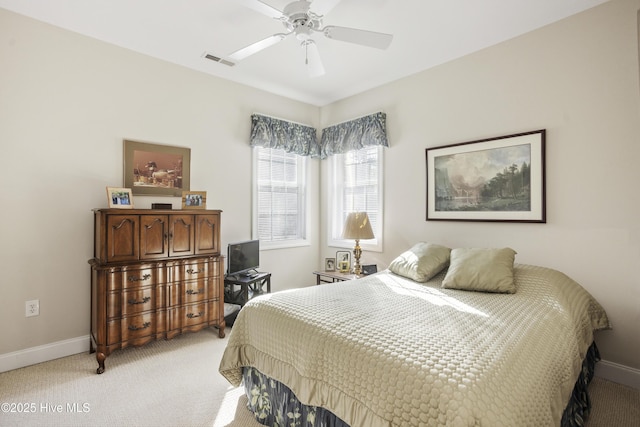 bedroom with light carpet, baseboards, visible vents, and ceiling fan