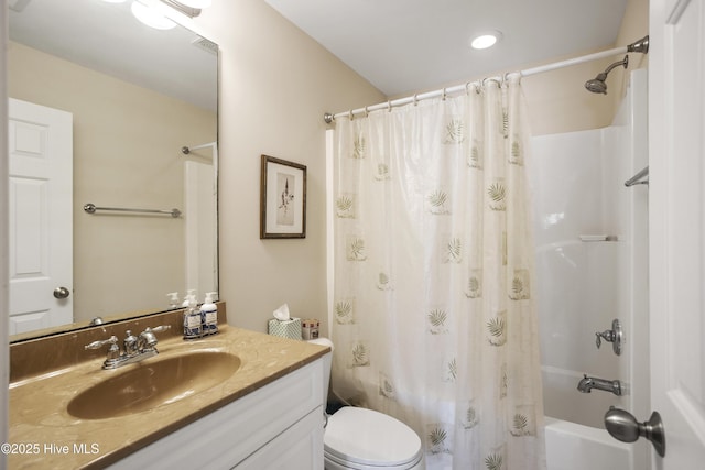 bathroom featuring toilet, shower / bath combo with shower curtain, and vanity