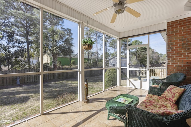 sunroom / solarium with a ceiling fan