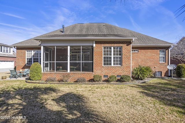 rear view of house featuring a sunroom, crawl space, brick siding, and a lawn