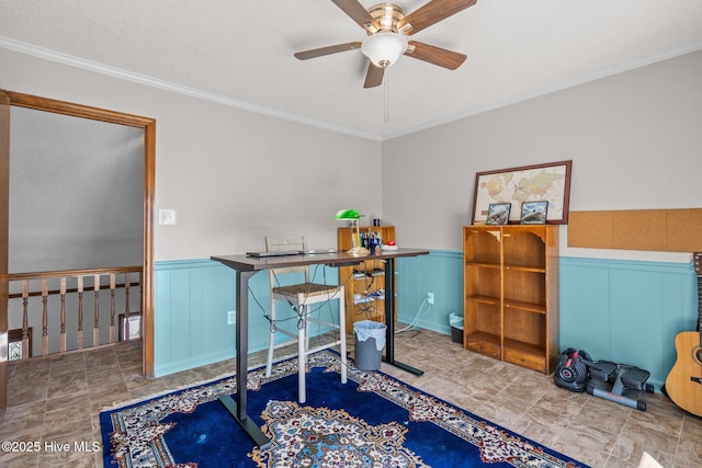 office with a ceiling fan, crown molding, and wainscoting