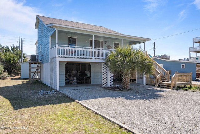 view of front of property with a garage, central AC unit, a front lawn, and a shingled roof