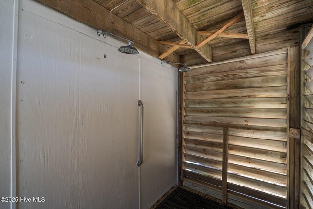 back of house with a storage shed, a wooden deck, stairs, and an outbuilding