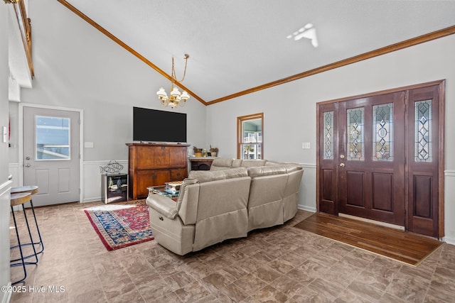 living room featuring a chandelier, high vaulted ceiling, and ornamental molding