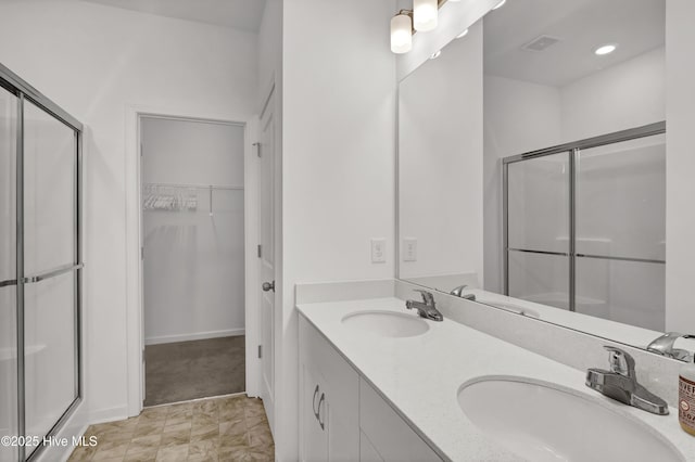 full bathroom with a stall shower, a sink, and visible vents