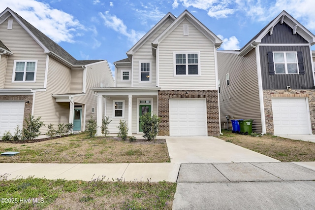 view of front of home with an attached garage, board and batten siding, concrete driveway, and brick siding