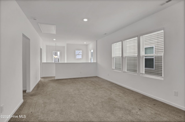 carpeted empty room with visible vents, recessed lighting, attic access, and baseboards