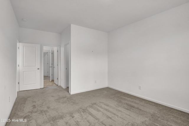 unfurnished bedroom with carpet and baseboards