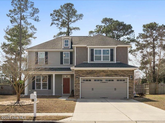 view of front of home with a garage, concrete driveway, stone siding, and fence