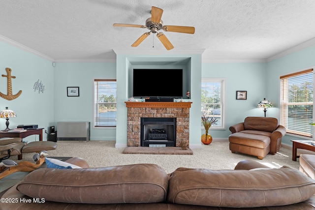 living area featuring crown molding, carpet flooring, baseboards, and ceiling fan