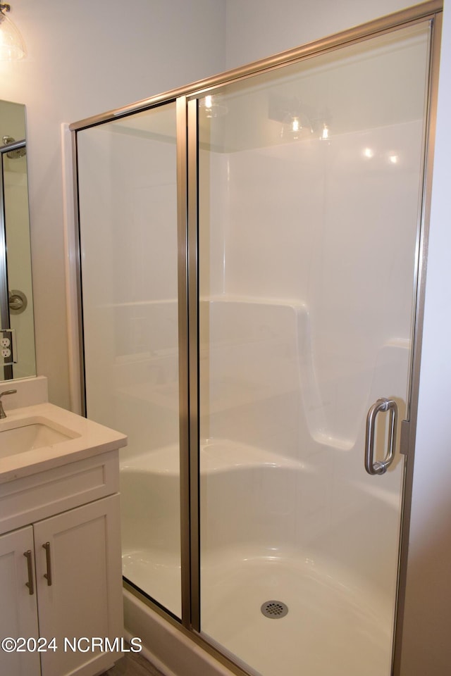 full bath featuring a stall shower and vanity