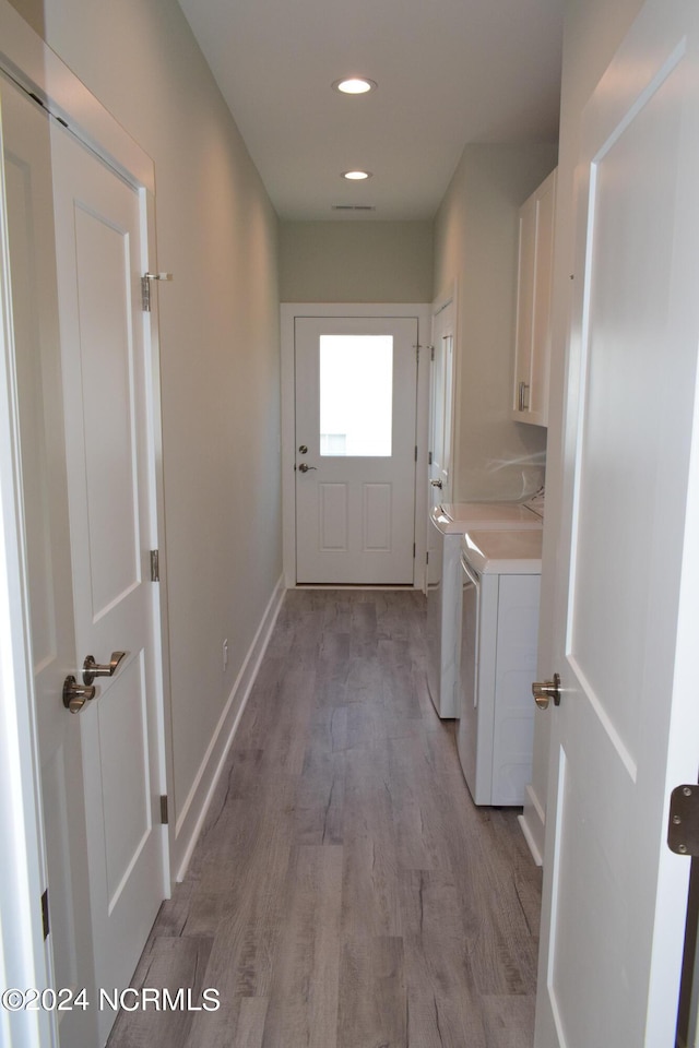 clothes washing area with cabinet space, baseboards, independent washer and dryer, light wood-style floors, and recessed lighting