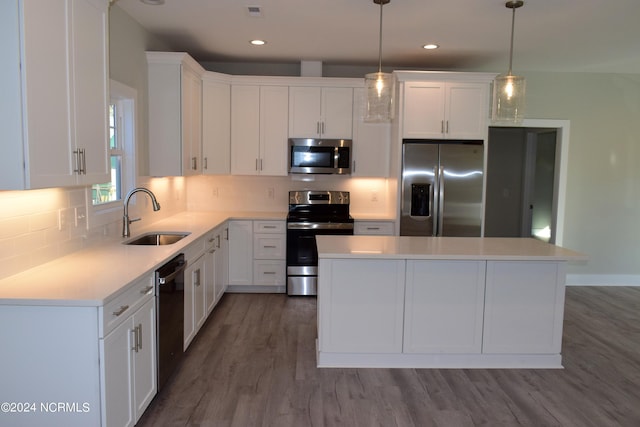 kitchen featuring appliances with stainless steel finishes, a sink, and white cabinetry