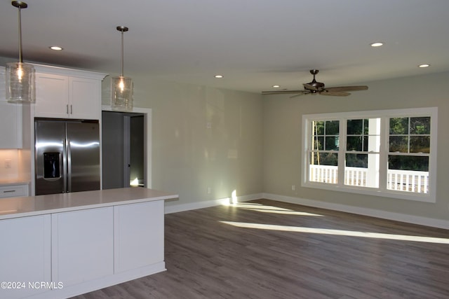 kitchen featuring dark wood-style floors, pendant lighting, light countertops, white cabinetry, and stainless steel fridge with ice dispenser