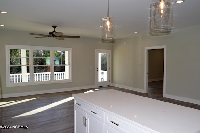 interior space featuring recessed lighting, open floor plan, white cabinets, and dark wood-style flooring