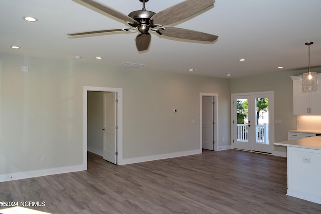 unfurnished living room featuring recessed lighting, visible vents, wood finished floors, and french doors