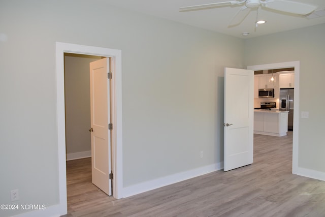 spare room with baseboards, recessed lighting, a ceiling fan, and light wood-style floors