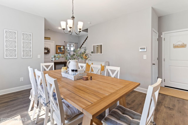 dining space with stairs, an inviting chandelier, wood finished floors, and baseboards