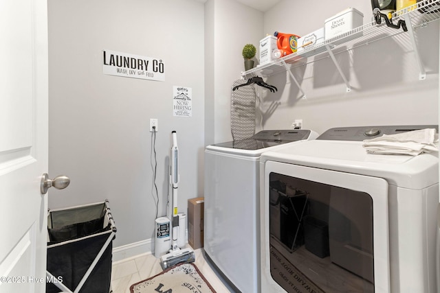 clothes washing area with laundry area, marble finish floor, baseboards, and separate washer and dryer