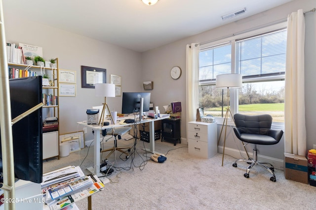 carpeted office with baseboards and visible vents