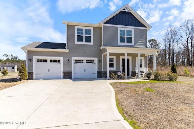 craftsman-style house with a garage, concrete driveway, stone siding, a porch, and board and batten siding