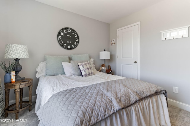 bedroom with carpet flooring and baseboards