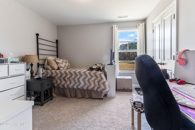 bedroom featuring light carpet and visible vents