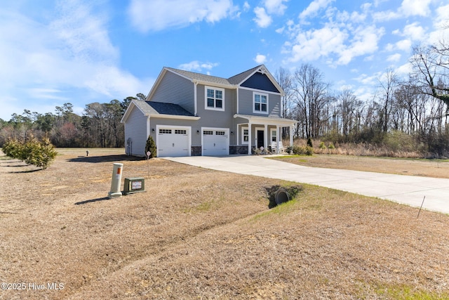 traditional-style home featuring covered porch, concrete driveway, stone siding, and an attached garage