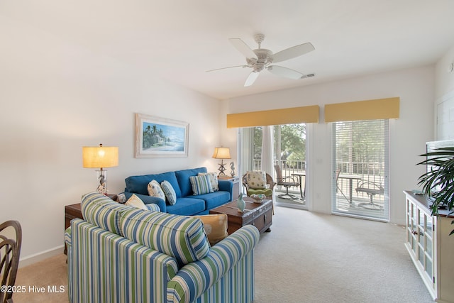 living room with light carpet, ceiling fan, visible vents, and baseboards