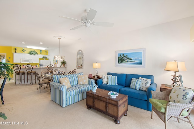 living room with recessed lighting, a ceiling fan, and light colored carpet