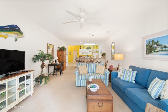 carpeted living room featuring ceiling fan